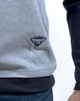 Imagen de acercamiento de playera de manga larga con cuello redondo color gris con marino marca Bros Club